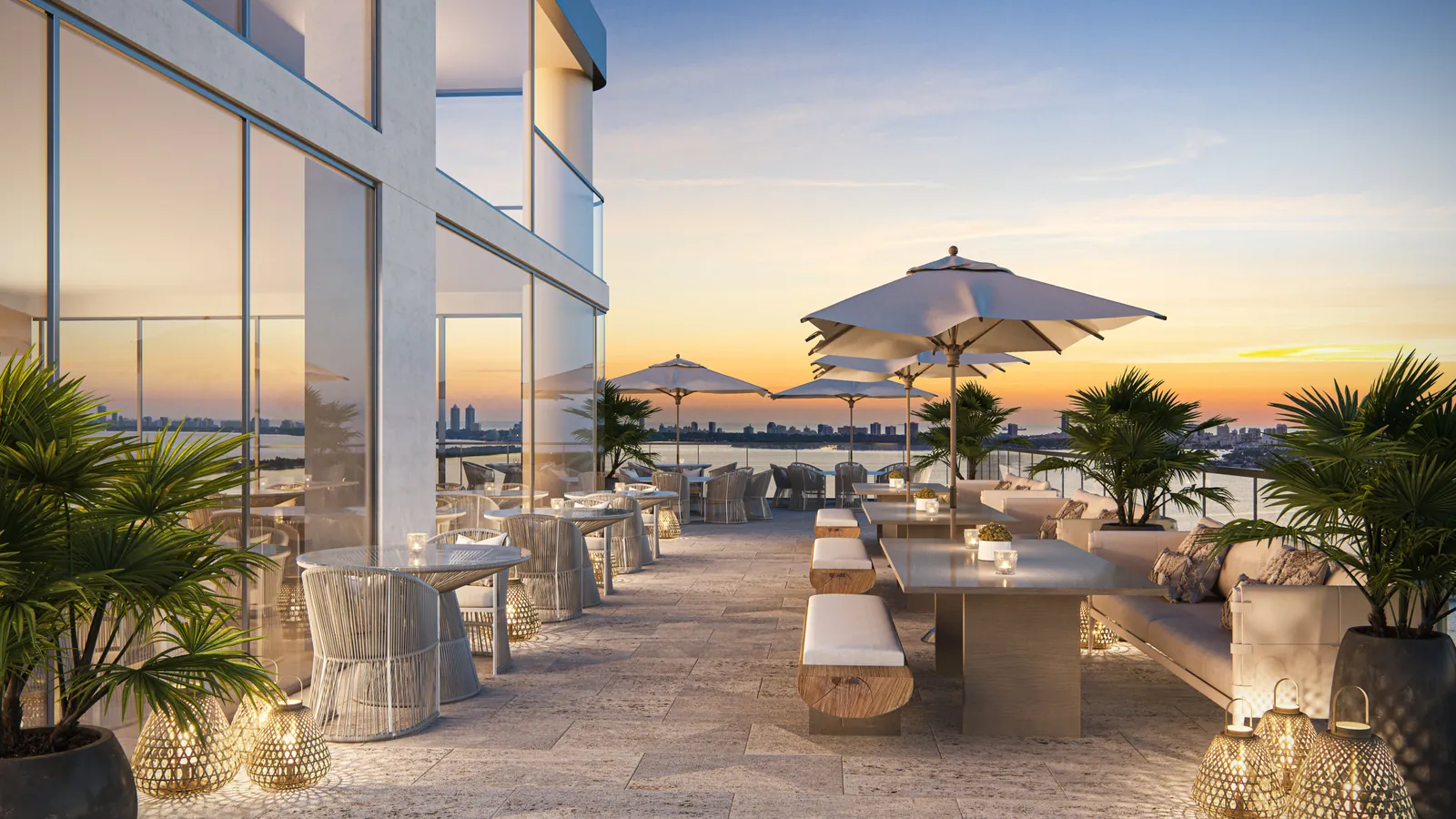 Bayfront terrace with lounge seating and sunset views at Aria Reserve Miami